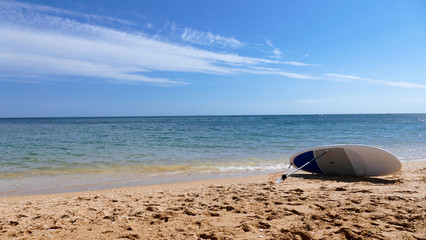 Fototapeta na wymiar Surfing board at the beach with blue sky background