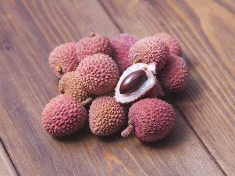 fresh lychee fruits on wooden background