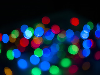 Colorful Christmas lights bokhe on black