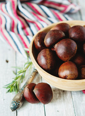 Fresh chestnuts in yellow bowl
