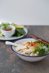 Pho ga- Vietnamese chicken noodle soup with crispy fried shallots and fresh herbs 