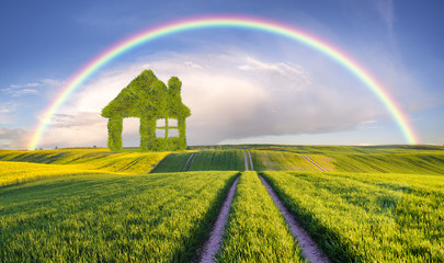 Naklejka premium concept green house built of leaves standing on a green, ecologi