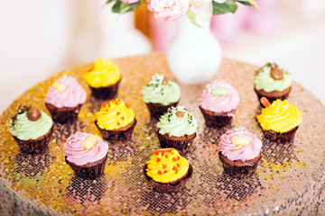 Cupcakes. yellow, green and pink cakes.