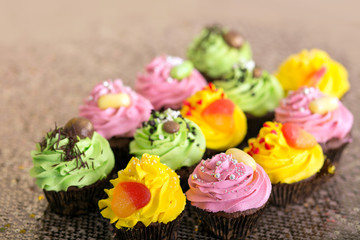 Cupcakes. yellow, green and pink cakes.
