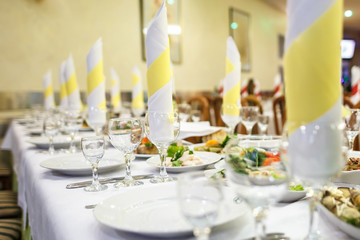 View of the served for decorated wedding dinner table.