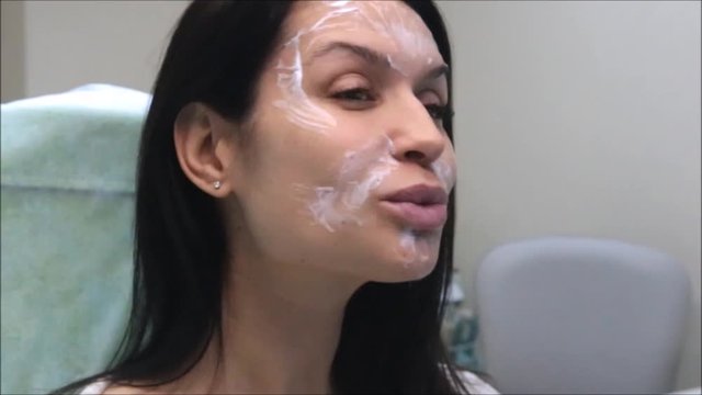Beautiful brunette girl is waiting the effect of the cream on her face