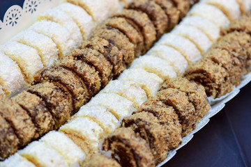 Pastry rolls with coconut and nuts on the table in natural light