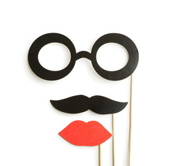 fake lips, glasses and mustaches on sticks