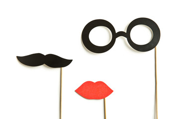 fake lips, glasses and mustaches on sticks