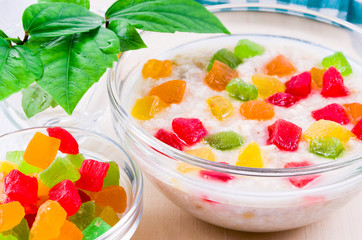 Healthy oatmeal close-up with colorful candied fruit
