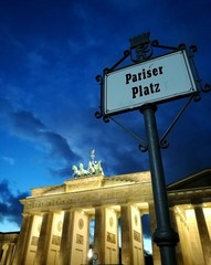BERLIN, GERMANY - DECEMBER 26, 2016: Night view of Brandenburg gate behind the Pariser platz sign at Berlin, Germany. © Photographer