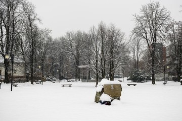 Benches in the park covered by snow in winter. Slovakia