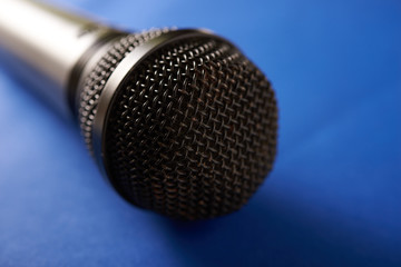 black microphone on a blue background