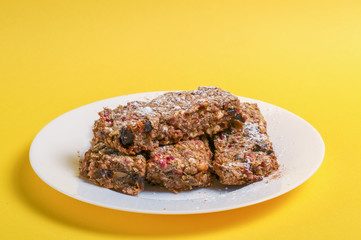 cookies with nuts in a white plate on a yellow background