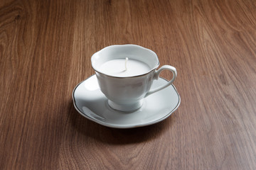 candle in a tea cups
