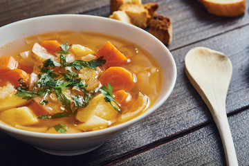 Vegetable soup in white bowlon wooden table