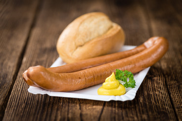 Wooden table with Wiener Sausages (selective focus)