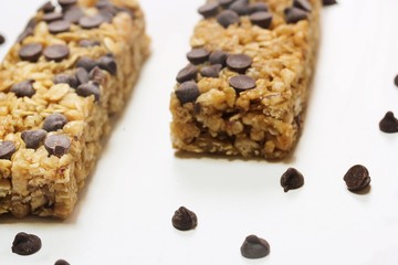 Chocolate chip granola bars isolated on white, selective focus