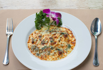 Spinach with cheese baked on white plate,Italian food