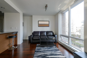 Modern apartment living room and kitchen with a view of downtown. Interior design.