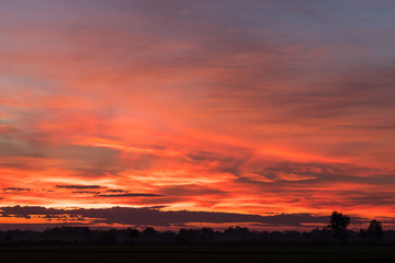 Sky orange and yellow countryside.