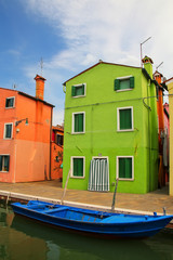Fototapeta na wymiar Colorful house by canal in Burano, Venice, Italy.