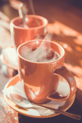 Cups of tea on a wooden table.