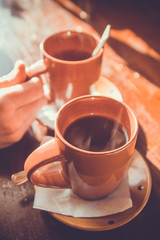 Cups of tea on a wooden table.