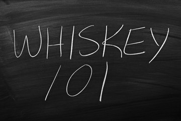 The words "Whiskey 101" on a blackboard in chalk