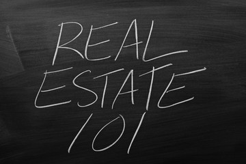 The words "Real Estate 101" on a blackboard in chalk