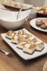 Vanilla Cheesecake squares swirled with caramel, with cold cuts