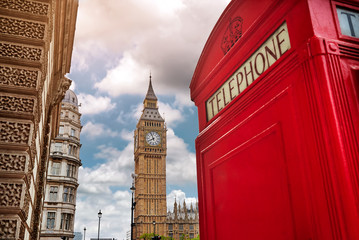 London - Big Ben tower and a red phone booth