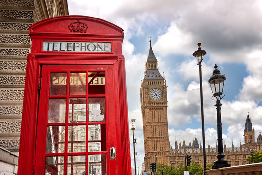 London - Big Ben tower and a red phone booth