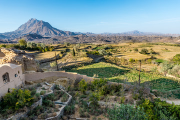 Fototapeta na wymiar Rural landscape with fields seen from abandoned mud brick village of Kharanaq in Iran