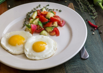 Appetizing fried eggs for breakfast. Fried eggs with herbs