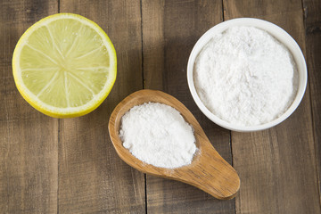 Baking soda and lemon on wooden table