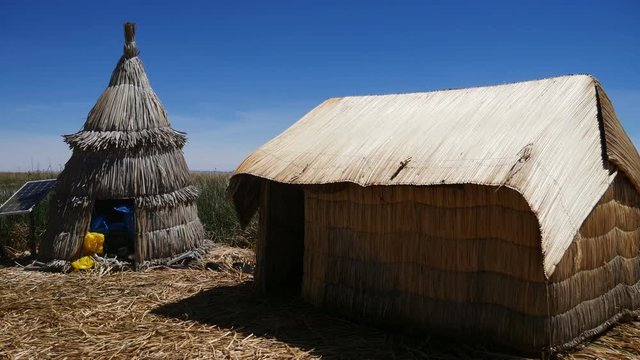View of the Uros floating reed islands with boats, mysterious Lake Titicaca, Puno Region, Peru