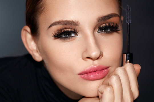 Beauty. Woman With Beautiful Face And Mascara Brush In Hand