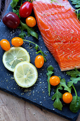 fresh raw salmon fillet with aromatic herbs, spices