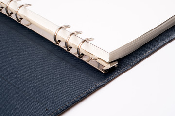 Open blank note book on white background.