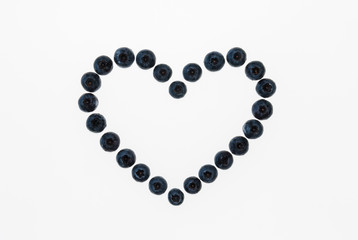 closeup of isolated blueberry heart on white background