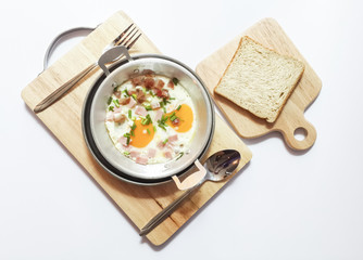 Breakfast with egg pan and Sliced ​​bread on Chopping Wood