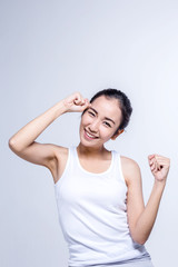 Beautiful brunette Asian girl in white tshirt stretching, relaxi