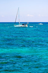 Fototapeta premium Florida Keys turquoise water in the coral diving area. The boat, waiting for divers. Vertical composition.
