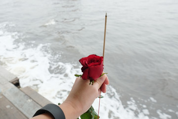 red rose and incense for funeral ceremony