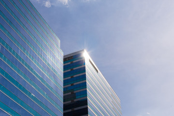 Fototapeta na wymiar Glass office building with blue sky