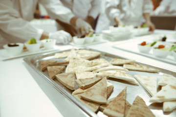 chef using chopsticks tong sliced beef put on the white plate in
