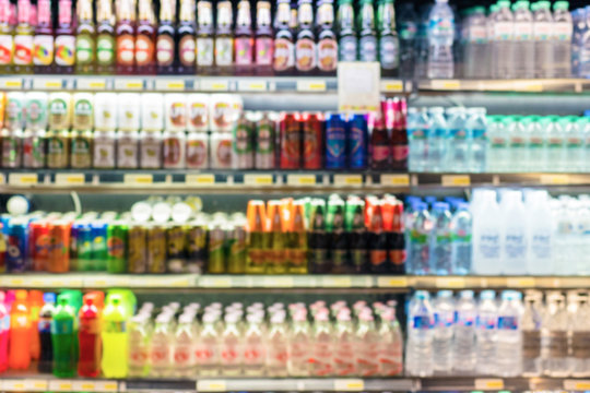 Defocused blur of supermarket shelves with Bottles of Beverages