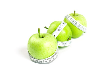 green apple with Measuring tape on white background in concept o