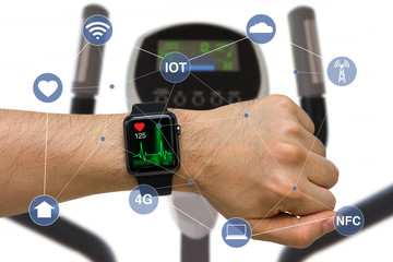 Smart Watch Monitoring Heart Rate Application Concept While Exercising with Elliptical Machine